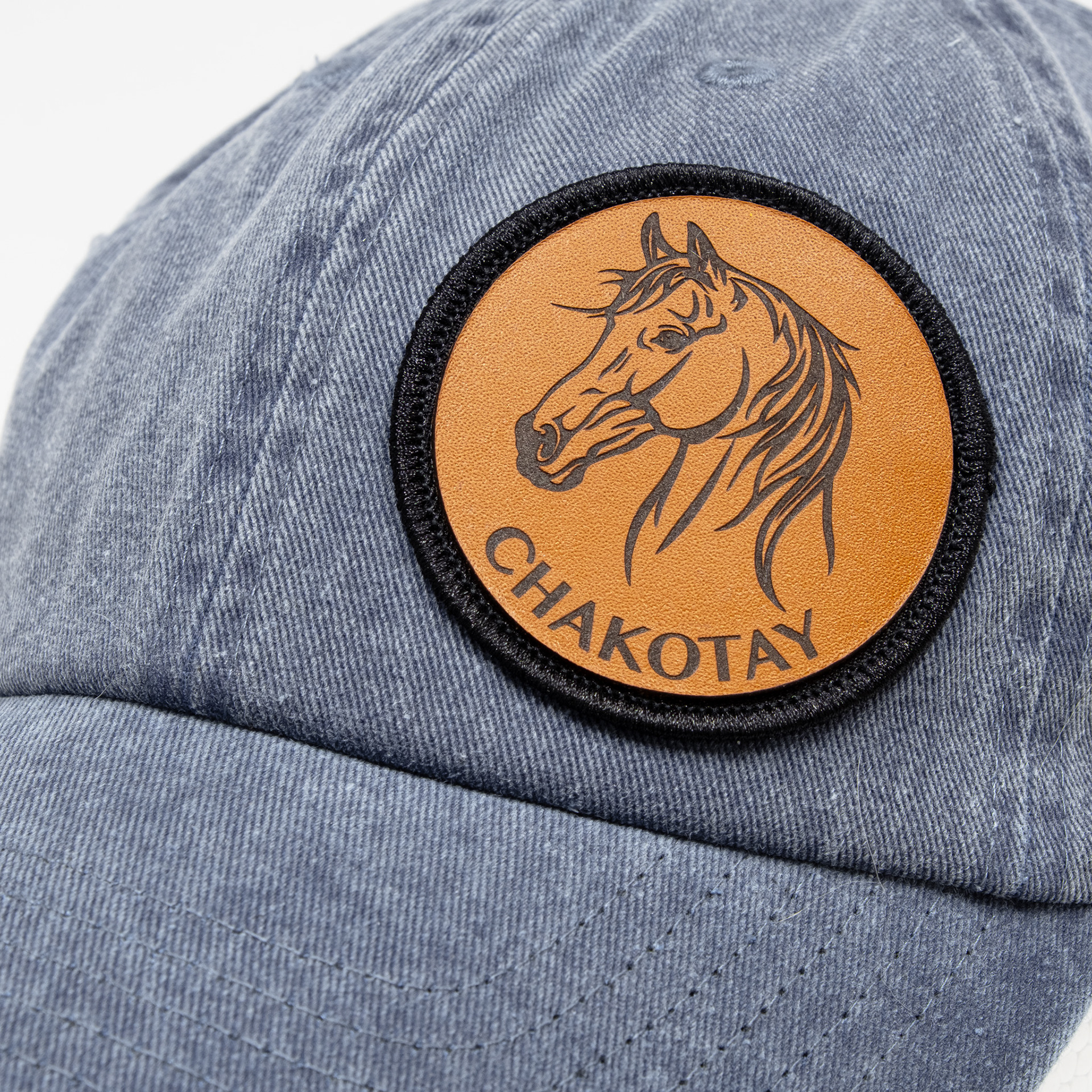 Blue cap with engraved leather horse patch