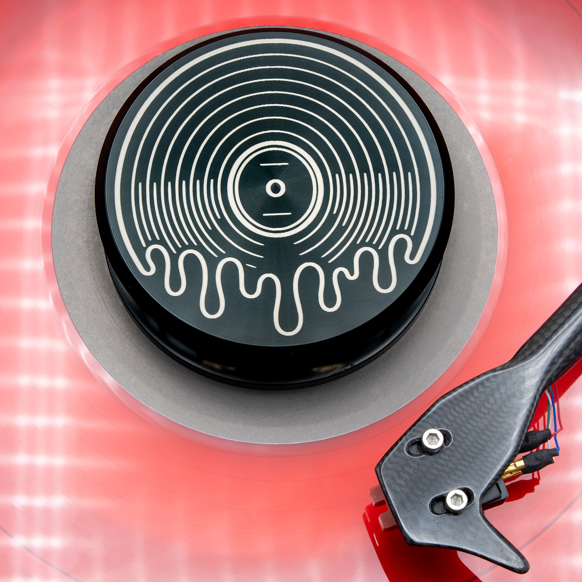 Melting vinyl record design on an engraved record weight