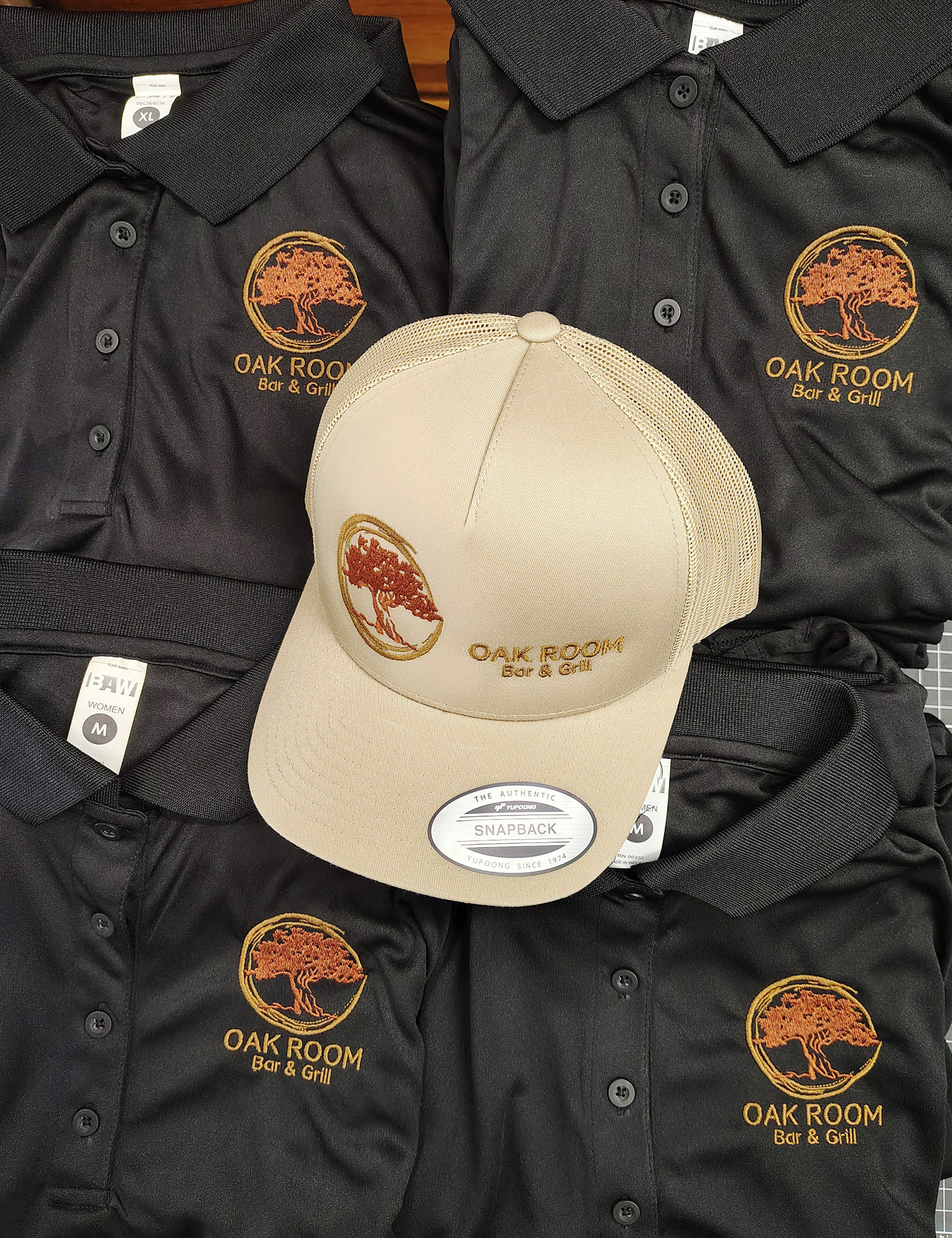 Cream custom cap beside embroidered business apparel