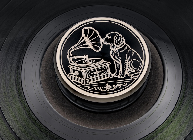 Dog and gramophone engraved on a black record weight